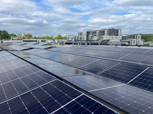High-efficiency solar panels on flat commercial roof at Sopers House Hertfordshire